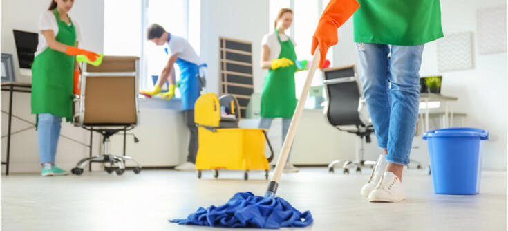 Janitorial staff cleaning an office